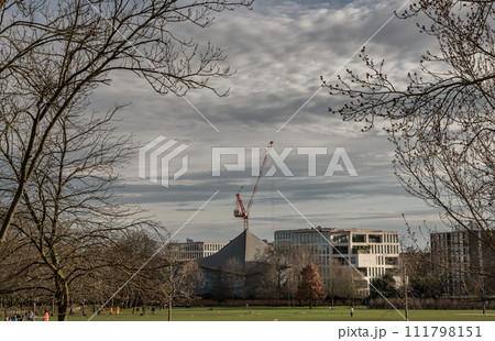 Construction work with crane and Hyperbolic-paraboloid roof of The design museum with sky background. 111798151