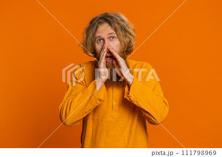 Caucasian young man whisper news rumors holding hands near mouth share gossip quiet keep my secrets 111798969