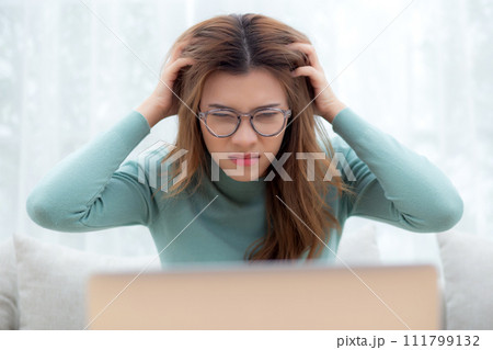 Young asian woman wearing glasses expression with frustration and stress sitting on sofa. Young asian woman wearing glasses expression with frustration and stress sitting on sofa. 111799132
