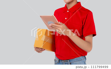 Young asian man carrying box and looking document on digital tablet isolated white background. 111799499