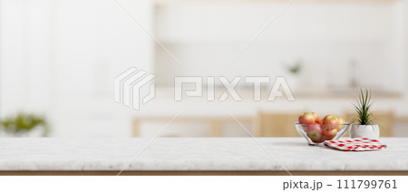 A white marble kitchen countertop with empty space for product display in a modern white kitchen. 111799761