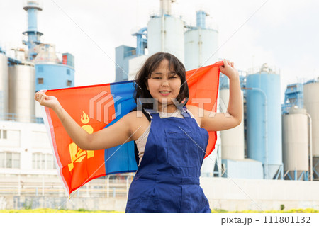 Happy young woman with flag of Mongolia against background of factory Happy young woman with flag of Mongolia against background of factory 111801132