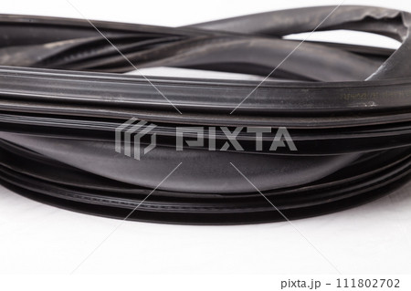 Rolled up black rubber sealant for elements of the car body, doors or trunk, for noise insulation, thermal and sound, preventing heat loss in the car interior. Sealing gasket for repair in a workshop. Rolled up black rubber sealant for elements of the car body, doors or trunk, for noise insulation, thermal and sound, preventing heat loss in the car interior. Sealing gasket for repair in a workshop. 111802702