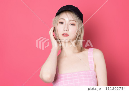 ピンク背景で撮影をした若い女性のポップなポートレート 111802754