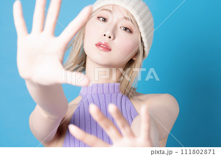 青背景で撮影をした若い女性のポップなメイクアップイメージ 111802871