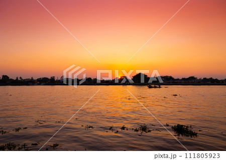 dusk dawn river view sunset orange sky. evening silhouette boat quiet calm chaophraya riverside landscape 111805923