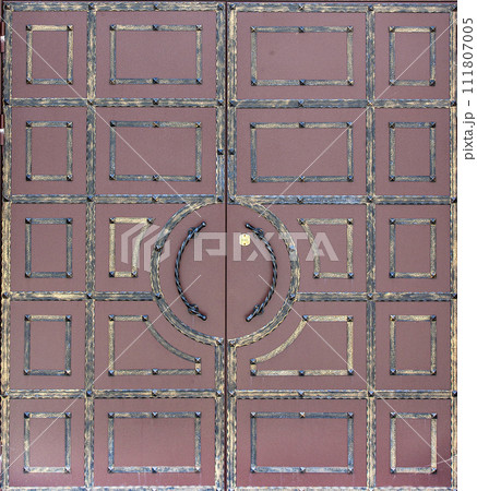 Antique metal doors to the church. Selective focus Antique metal doors to the church. Selective focus 111807005