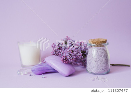 Cosmetics, soap and bath salts and lilac flowers on the background, an even layer 111807477