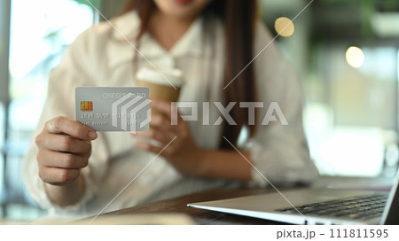 Businesswoman holding credit card. Online internet banking and Secure payments concept Businesswoman holding credit card. Online internet banking and Secure payments concept 111811595