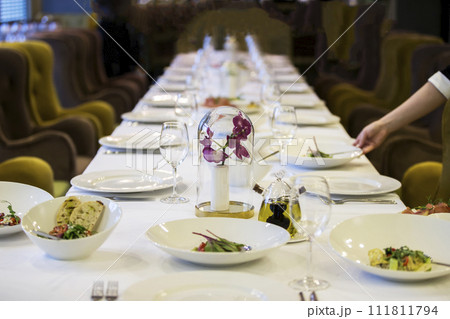 Served table in the restaurant. Lots of empty plates. Preparing for the buffet. 111811794