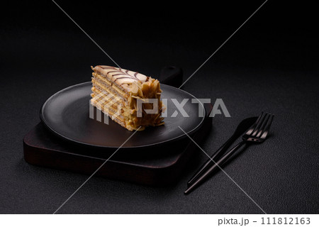 Piece of delicious sweet esterhazy cake with nuts and cream 111812163