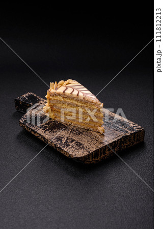 Piece of delicious sweet esterhazy cake with nuts and cream 111812213
