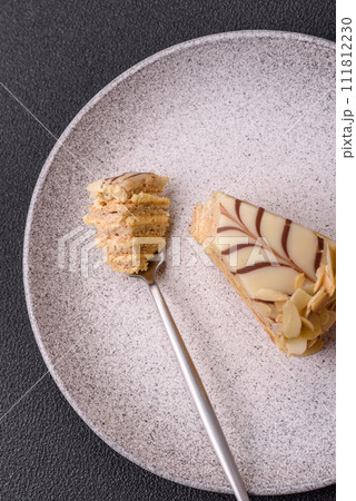 Piece of delicious sweet esterhazy cake with nuts and cream 111812230