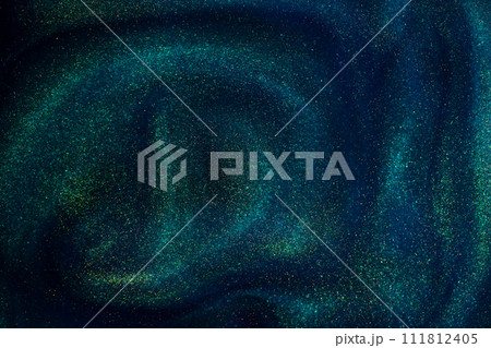 Abstract magic blue background with golden sparkles. Photo of a blue liquid with gold glitters and green tints. Various shades of green and blue with golden splashes and flows.  111812405