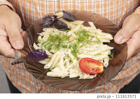 On a plate of pasta, tomato basil and dill. 111813571