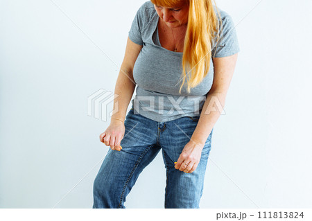 Gynecologic problems, urinary incontinence, female health. Woman showing off wet jeans 111813824