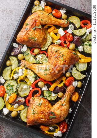 Greek Sheet Pan Chicken With Vegetables and Feta closeup. Vertical top view 111815609