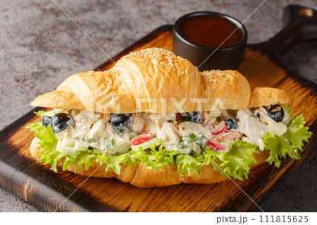 Homemade Healthy Chicken Salad Croissant Sandwich closeup on a wooden board. Horizontal 111815625