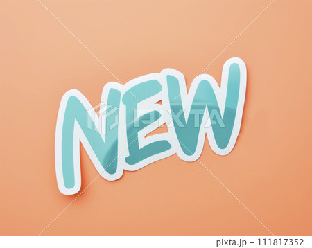 New, icon. New sign on a coral background. Phrase New on sticker on peach background. 111817352