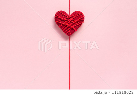 ピンク色の背景に赤色のハート　糸でぐるぐるに巻いたハート 111818625