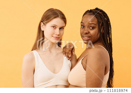 Studio portrait of two gen Z Black and Caucasian women wearing comfortable bras posing for camera Studio portrait of two gen Z Black and Caucasian women wearing comfortable bras posing for camera 111818974