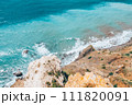 Large waves crash on the rocky shore view from above.  111820091