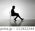 Silhouette of a man sitting on a chair 111822244