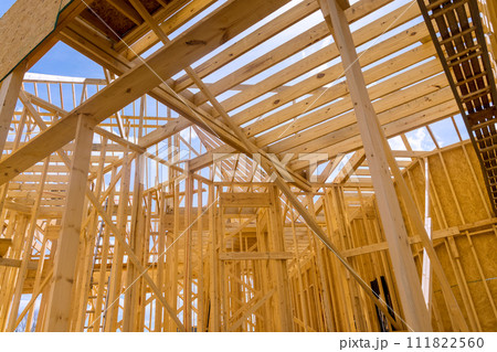 An framing beams used in construction of wooden framework for new house that is under construction 111822560