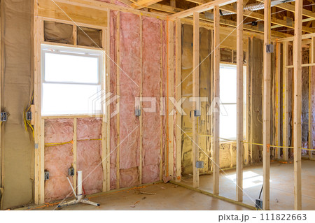 An installation of thermal fiberglass insulation mineral rock wool in new home An installation of thermal fiberglass insulation mineral rock wool in new home 111822663