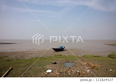Boats of fishermen stranded in the mud at low tide on the coast of Bay of Bengal, India Boats of fishermen stranded in the mud at low tide on the coast of Bay of Bengal, India 111824527
