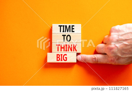 Time to think big symbol. Concept words Time to think big on beautiful wooden block. Beautiful orange table orange background. Businessman hand. Business and time to think big concept. Copy space. Time to think big symbol. Concept words Time to think big on beautiful wooden block. Beautiful orange table orange background. Businessman hand. Business and time to think big concept. Copy space. 111827165
