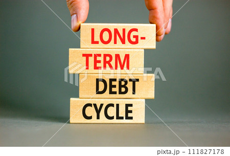 Long-term debt cycle symbol. Concept words Long-term debt cycle on beautiful wooden block. Beautiful grey table grey background. Businessman hand. Business Long-term debt cycle concept. Copy space. 111827178