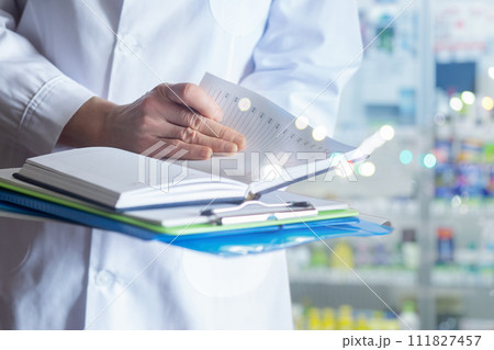 Pharmacist writes journal prescription . Pharmacist writes journal prescription . 111827457