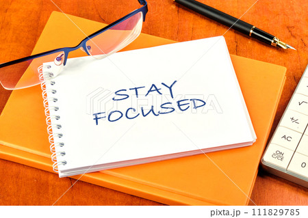Motivation concept. STAY FOCUSED written on a clean white notebook Motivation concept. STAY FOCUSED written on a clean white notebook 111829785