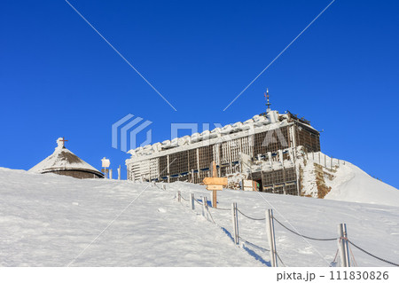 Wooden building of new post office with souvenirs and postcards in snezka, mountain on the border between Czech Republic and Poland, winter, morning  time. 111830826