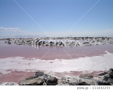 Spiral Jetty inner circles of spiral with bubbles in the pink water 111832255
