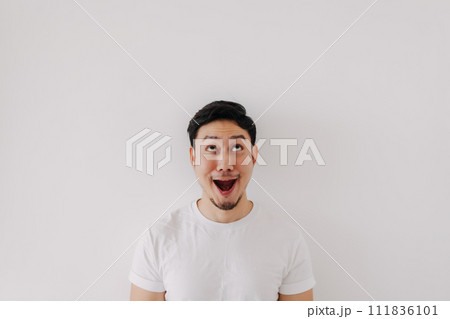 Happy funny big smile face of man wears white t-shirt portrait isolated on white background. Happy funny big smile face of man wears white t-shirt portrait isolated on white background. 111836101