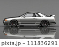 A sleek silver car with shiny alloy wheels parked on a gray surface 111836291