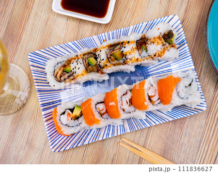 Set of japanese rolls uramaki with eel, avocado, prawns, and salmon Set of japanese rolls uramaki with eel, avocado, prawns, and salmon 111836627