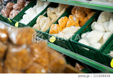 Various packaged bulk food products arranged on shelves in grocery store 111836838