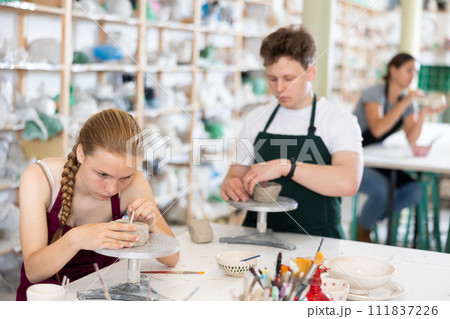 Teenagers are interested in making dishes from clay in pottery workshop 111837226