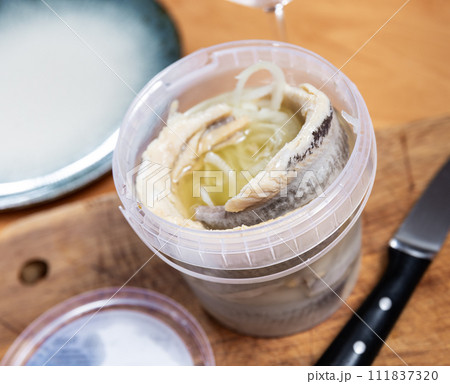 Pieces of pickled herring served with onions Pieces of pickled herring served with onions 111837320