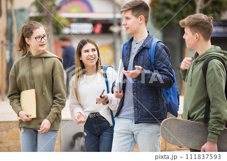 Teenagers have fun talking on street Teenagers have fun talking on street 111837593
