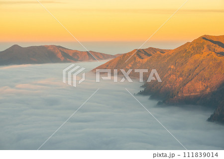 Beautiful view of the mountains with sea of fog in the area of Bromo Tengger Semeru National Park, Indonesia. Beautiful view of the mountains with sea of fog in the area of Bromo Tengger Semeru National Park, Indonesia. 111839014