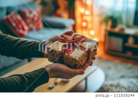 AI-generated content. A person is holding a wrapped present securely in their hand, ready to give it to someone. 111839244