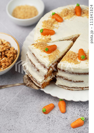 Homemade carrot cake made with walnuts, iced with cream cheese. Sweet dessert. Homemade carrot cake made with walnuts, iced with cream cheese. Sweet dessert. 111841824