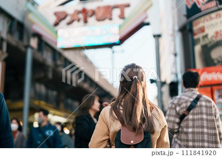 Tourist woman visit Ameyoko market, a busy market street located in Ueno. Landmark and popular for tourist attraction and Travel destination in Tokyo, Japan and Asia concept 111841920
