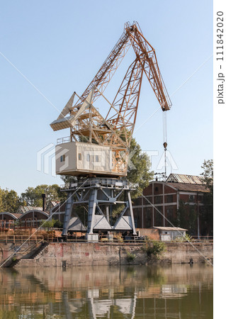 Portal crane is under blue sky on a sunny day 111842020