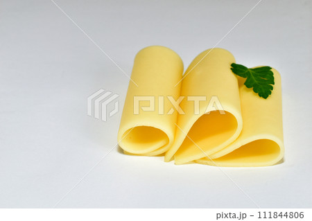 Plates of cheese lie on white. 111844806