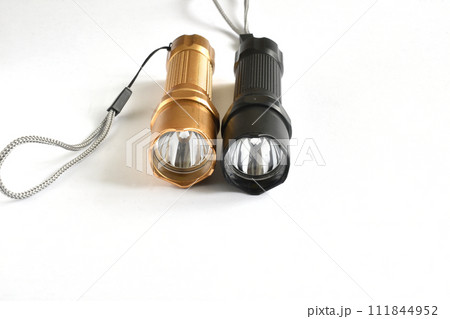 Two hand-held flashlights on a white background. 111844952